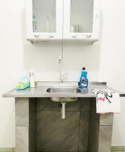 a kitchen counter with a sink in a room at Aeroporto House 4 in Macapá