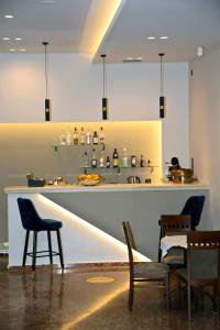 a bar in a restaurant with chairs and a counter at Hotel Marily in Pyrgos