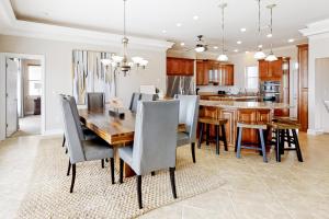 a kitchen and dining room with a wooden table and chairs at Windswept by Meyer Vacation Rentals in Gulf Shores