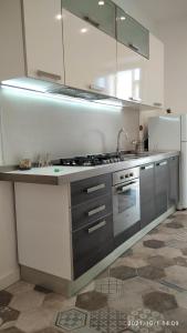 a kitchen with a sink and a refrigerator at La Maison Della Torre in Portici