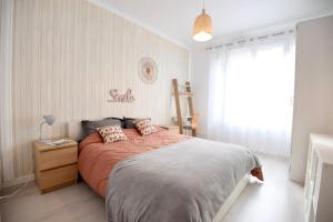 a bedroom with a large bed and a window at Charming T2 on the outskirts of Paris in Saint-Ouen +4 photos