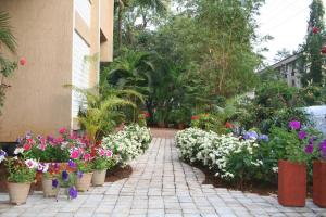 un jardín con muchas macetas de flores y plantas en Hotel Ferreira Resort, en Lonavala