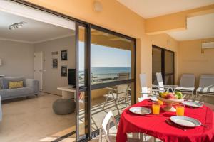 a living room with a table with a red table cloth at Marina Mar 'Penthouse' by SAPvillas in Vilamoura