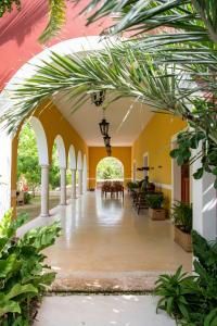 an arcade in a building with plants at Wakax Hacienda - Cenote & Boutique Hotel in Tulum