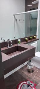 a bathroom with a sink and a mirror at Recanto de Minas in Piauí