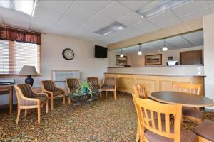 a waiting room with a table and chairs at Corn Palace Inn in Mitchell