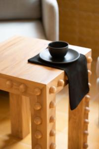 a wooden table with a black bowl on top of it at William Hotel Boutique De Diseño in Taxco de Alarcón