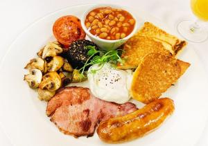 a plate of breakfast food with eggs sausage beans and toast at Motseleng Guest House in Palatswe
