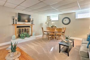 a living room with a table and a fireplace at Colonial Beach House with Patio 2 Blocks to Beach! in Colonial Beach