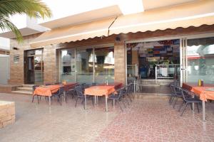 a restaurant with tables and chairs on a patio at Apartamentos San Francisco in San Antonio