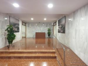 a hallway with stairs and potted plants in a building at Apartments soho, Malaga center in Málaga