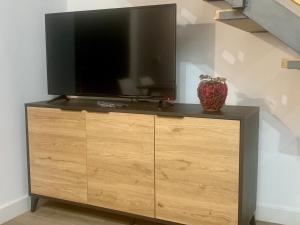 a television on top of a dresser in a room at Puerta de Caceres Apartamento 3 in Cáceres
