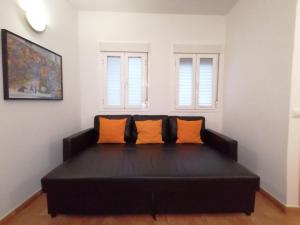 a living room with a couch and a window at Apartamentos El Puente in Madrid