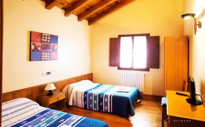 Postel nebo postele na pokoji v ubytování Hostal Musunzar