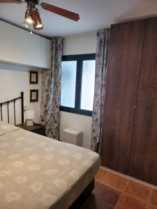 a bedroom with a bed and a large window at Appartamento Rosy Puerta del Sol in Caleta De Fuste