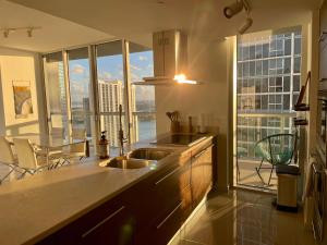 a kitchen with a sink and a large window at IconBrickell Tower 3 W Residences in Miami