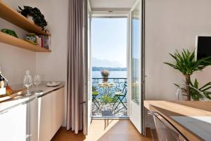 a kitchen with a large glass door leading to a balcony at Royal Cadenabbia in Griante Cadenabbia