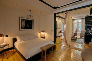 a bedroom with a bed and a surfboard in it at La Valise Mexico City in Mexico City