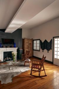 a living room with two chairs and a fireplace at La Valise Mexico City in Mexico City