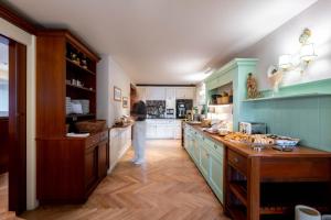 a woman standing in a kitchen with a counter at Boutique Hotel Bellevue Lermoos in Lermoos