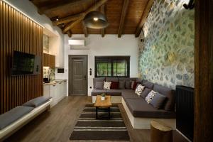 a living room with a couch and a table at Bocca al Lupo Villas in Kato Loutraki