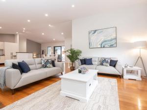 a living room with a couch and a table at Endless Summer at Smiths in Smiths Lake