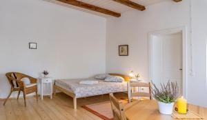 a small bedroom with a bed and a table at Pālena apartamenti in Tērvete