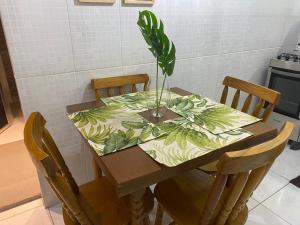 a dining room table with a potted plant on it at CASA_ESTRELA in Angra dos Reis