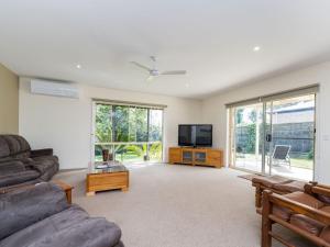 a living room with a couch and a tv at Woodland Heath Escape in Inverloch