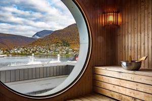 a mirror on a wall in a dimly lit room at Radisson Blu Hotel Tromsø in Tromsø