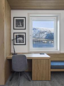 a desk with a window and a chair in a room at Radisson Blu Hotel Tromsø in Tromsø