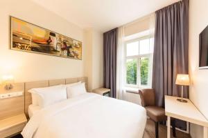 Кровать или кровати в номере Radisson Hotel Old Town Riga