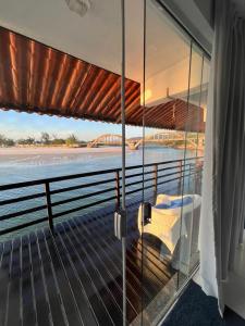 a balcony with a view of the water and a bridge at Casa Marambaia in Rio de Janeiro
