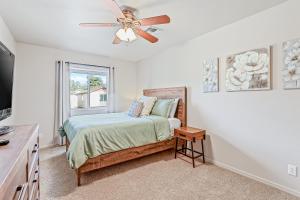 a bedroom with a bed and a ceiling fan at Desert Love in Flagstaff