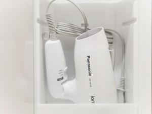 a shelf with two toothbrushes and a white appliance at Kevin's Place in Kyoto