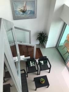 a living room with chairs and a table at Apartamentos Cartagena Marbella Suite in Cartagena de Indias