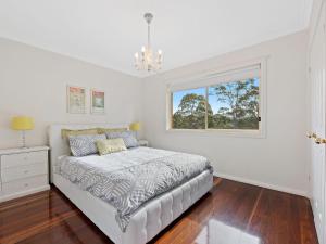 
a bedroom with a bed and a window at Gareth House in Narooma
