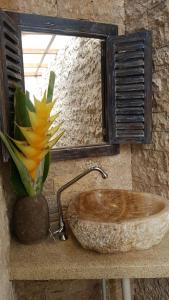 a bathroom with a wooden sink and a window at Geopark Village & Spa in Kintamani