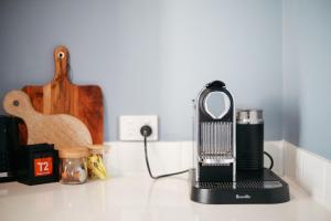 a blender sitting on top of a counter with a guitar at Figtree Retreat in Rothbury