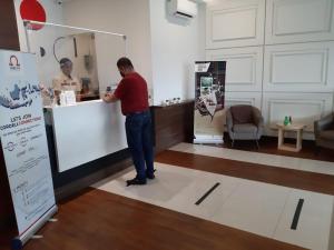 a man is standing at a counter in a store at Cordex Oase Pekanbaru in Pekanbaru