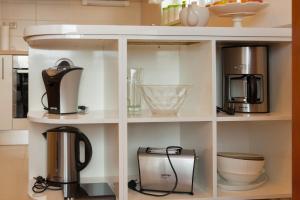 a shelf with various appliances on it in a kitchen at Apartments Maja in Omiš