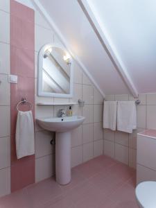 a bathroom with a sink and a mirror at Petite Sirene Studios in Paralia Katerinis