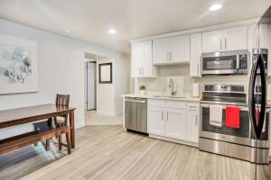 a kitchen with white cabinets and stainless steel appliances at New Furnished 2Bd Apt! Great for Long Stays in Vineyard
