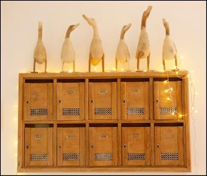 a wooden cabinet with six wine bottles on top at La Maison Rouge d'Uzes B&B in Uzès