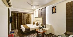 Cama o camas de una habitación en Atithi The Hotel