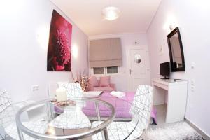 a living room with a glass table and a couch at Studios Ioulia in Keramot&iacute;