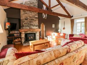 a living room with a couch and a fireplace at Monksmoor House in Middleton in Teesdale