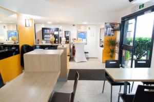 a restaurant with tables and chairs and a counter at Class'Eco Namur in Namur