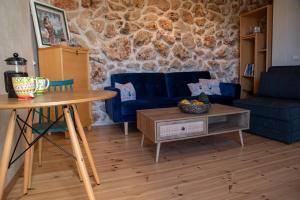 a living room with a blue couch and a table at Cozy Galilee Getaway in Abirim