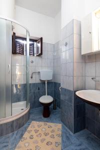 a bathroom with a shower and a toilet and a sink at Guest House Cesic in Dubrovnik